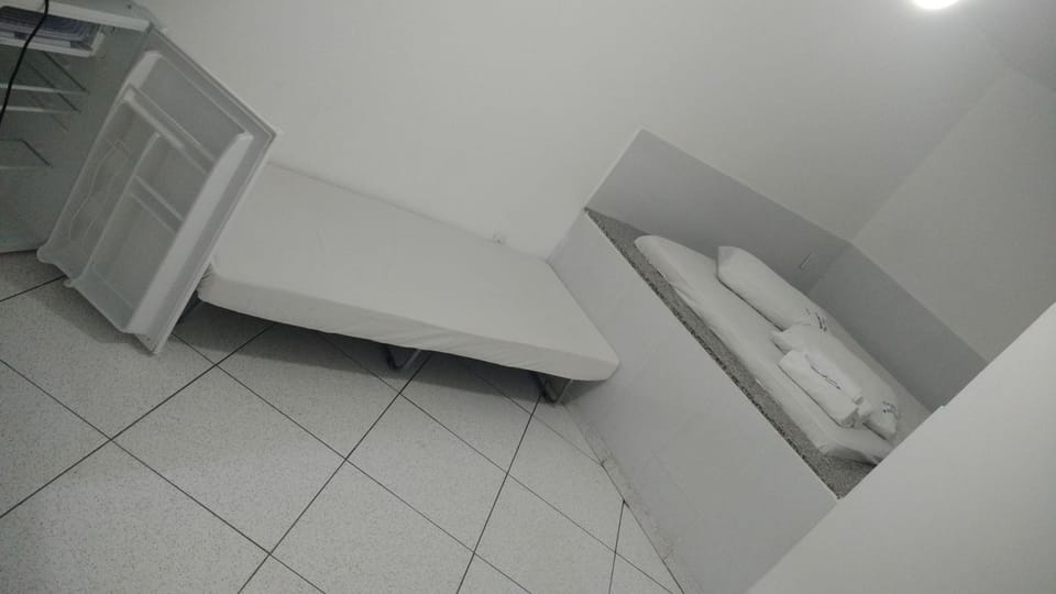 Economy Triple Room | Minibar, blackout drapes, bed sheets