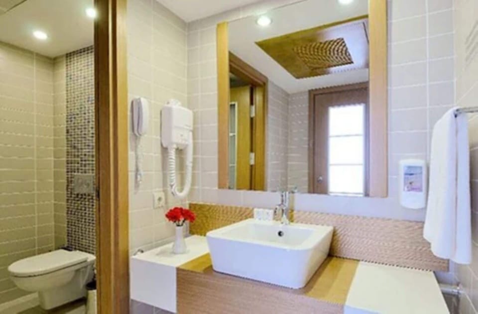 Shower, hair dryer, slippers, towels