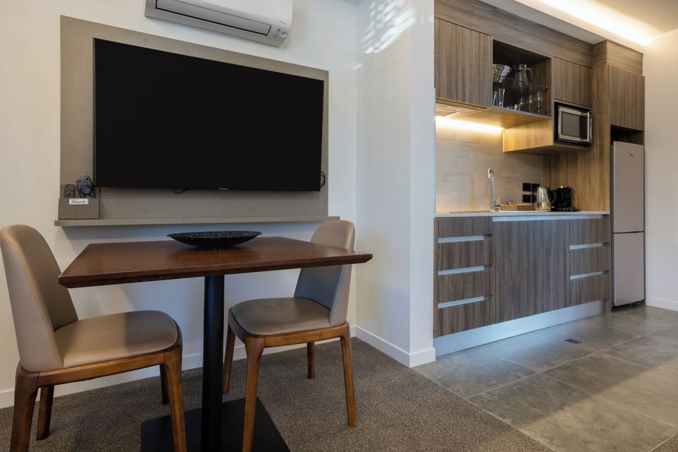 Luxury Studio Suite | Living area | Flat-screen TV