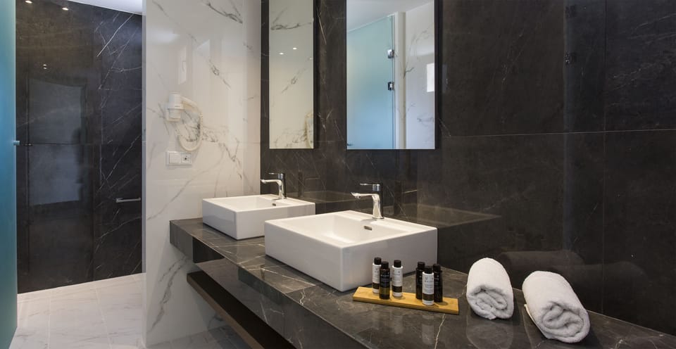 Designer toiletries, hair dryer, bathrobes, slippers