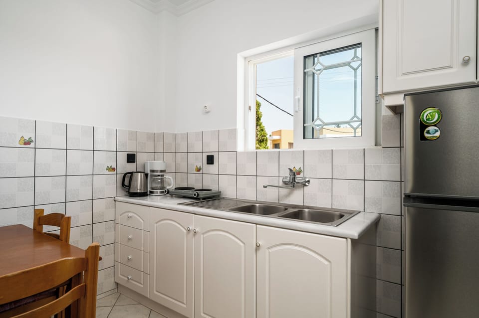 Apartment, 2 Bedrooms, Pool View, Poolside | Private kitchen | Fridge, stovetop, electric kettle, cookware/dishes/utensils