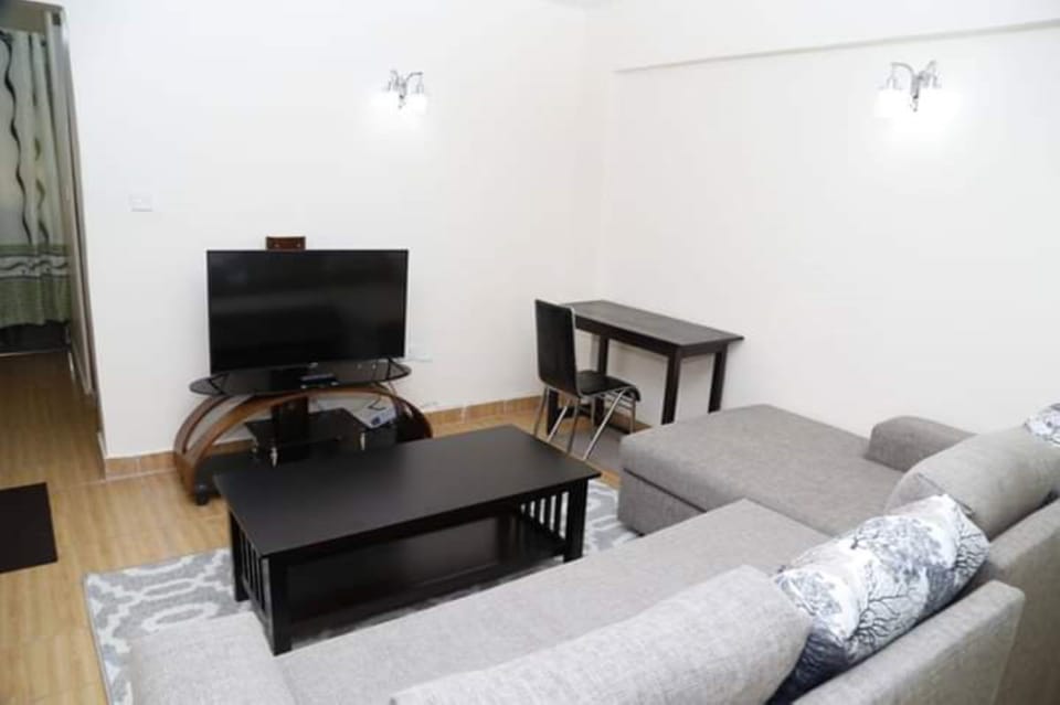 Apartment, 1 Bedroom | Living room | Flat-screen TV
