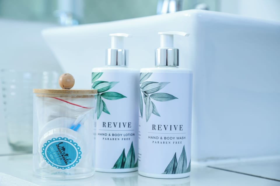Luxury Suite | Bathroom | Designer toiletries, hair dryer, towels, soap