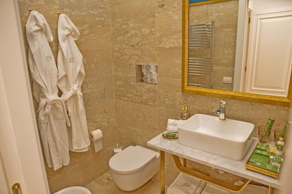 Junior Suite | Bathroom | Shower, designer toiletries, hair dryer, bathrobes