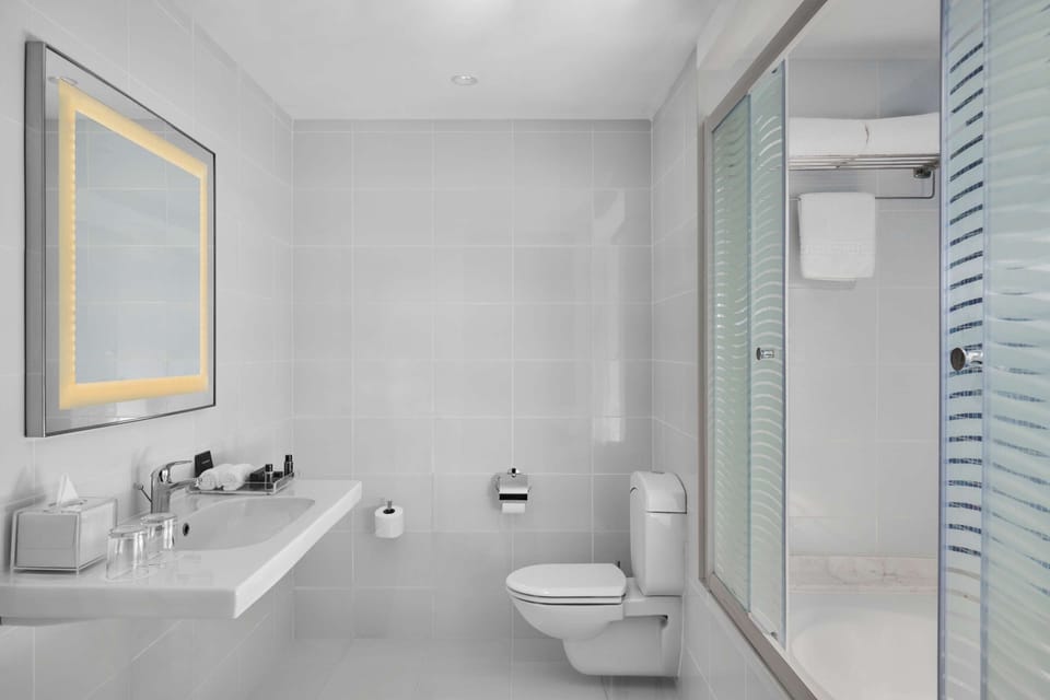 Suite, 1 King Bed, Sea View | Bathroom | Hair dryer, bathrobes, slippers, towels