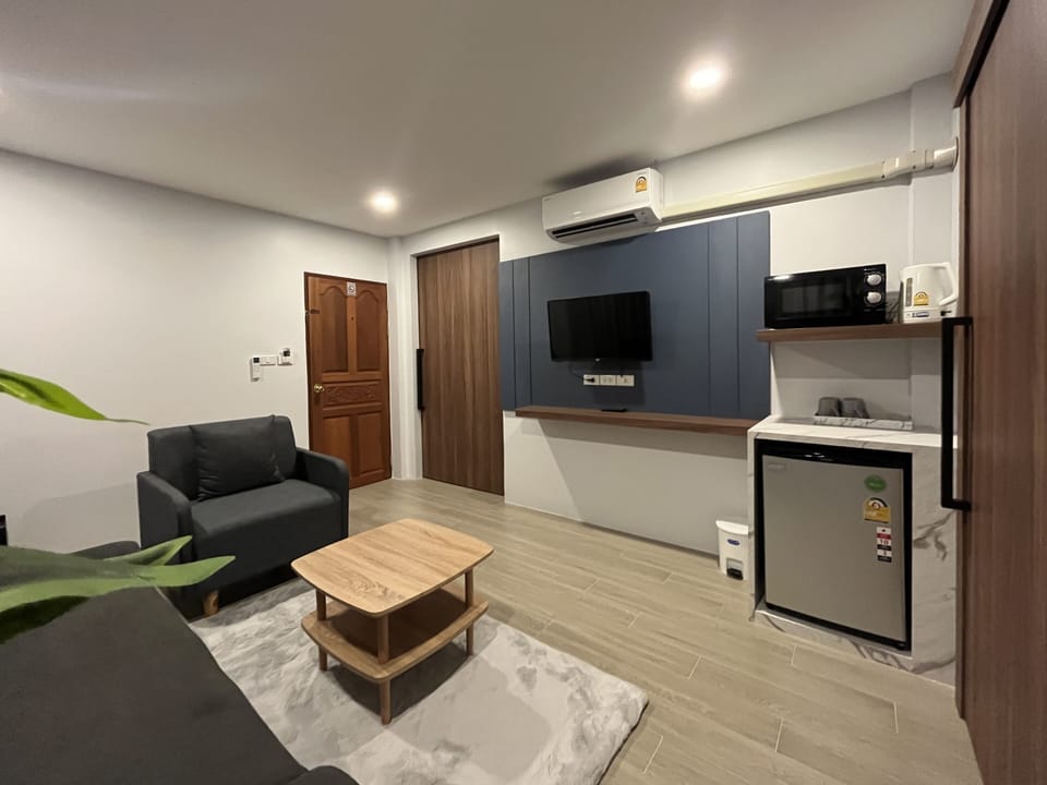 Deluxe Quadruple Room, 1 Bedroom | Living area | Flat-screen TV