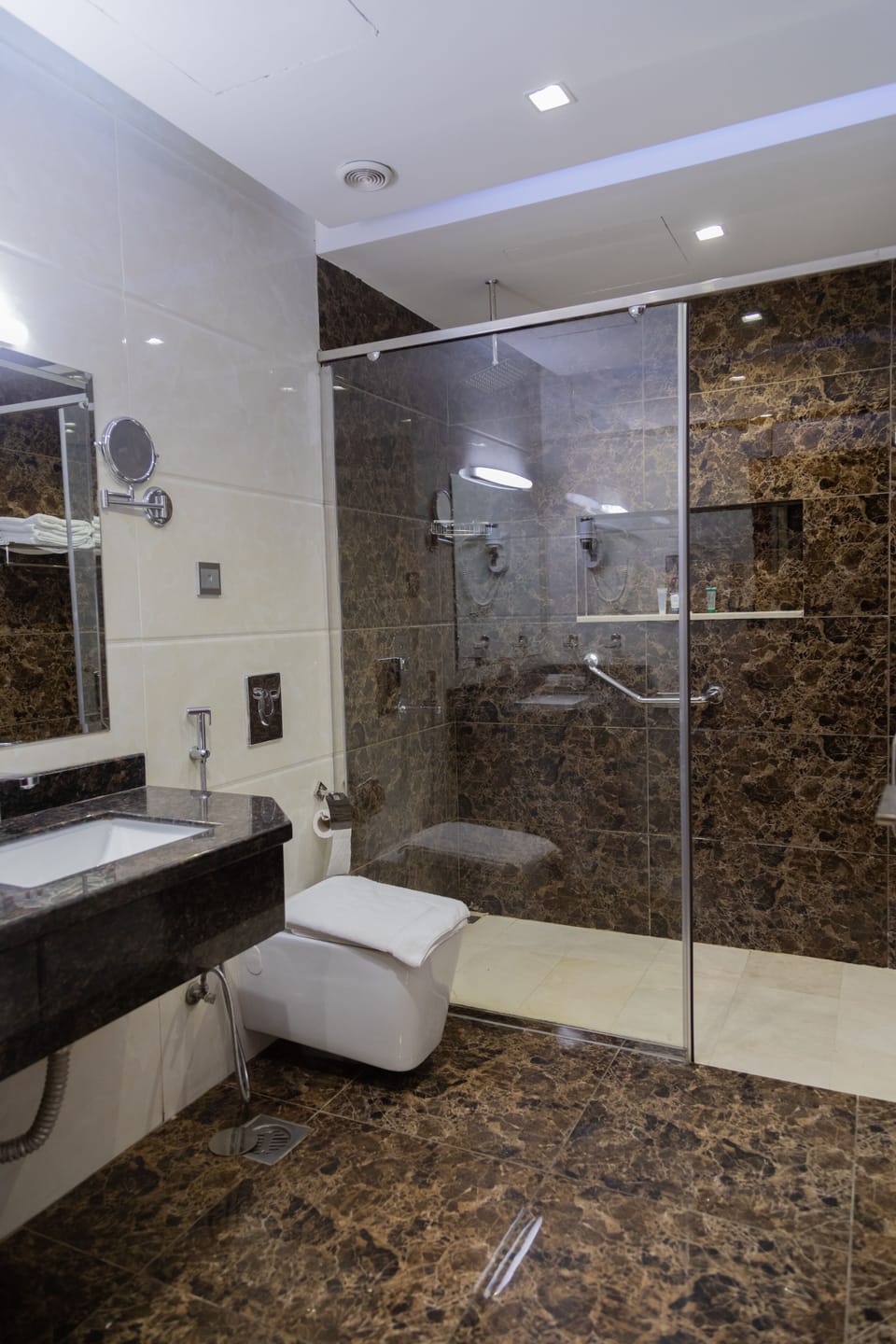 Shower, designer toiletries, hair dryer, slippers