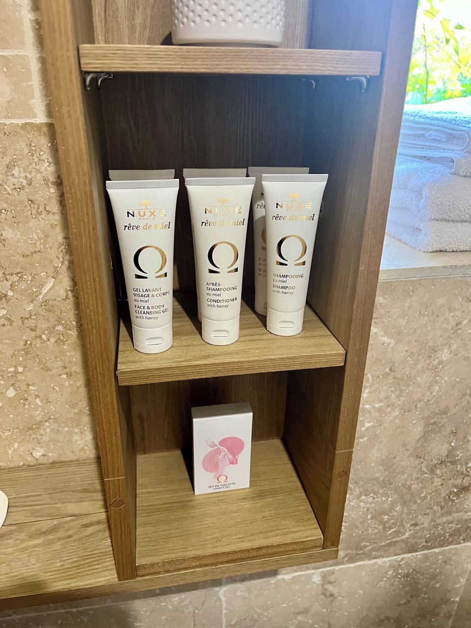 Designer toiletries, hair dryer, slippers, towels