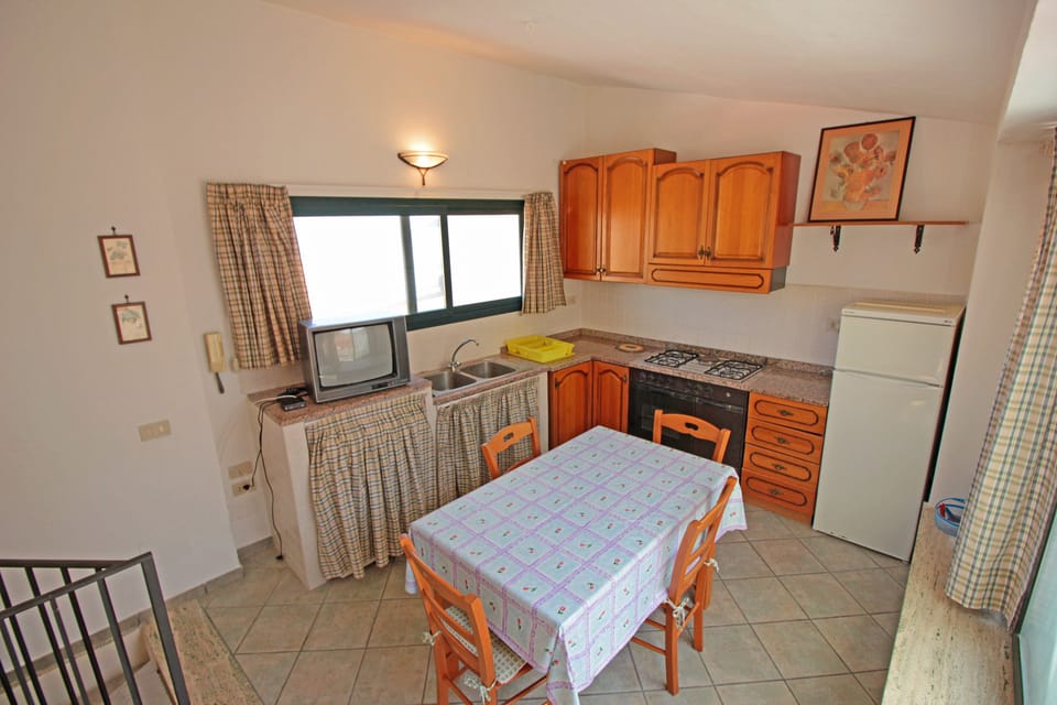 Apartment, 1 Bedroom | Private kitchen | Full-size fridge, stovetop, highchair, cookware/dishes/utensils
