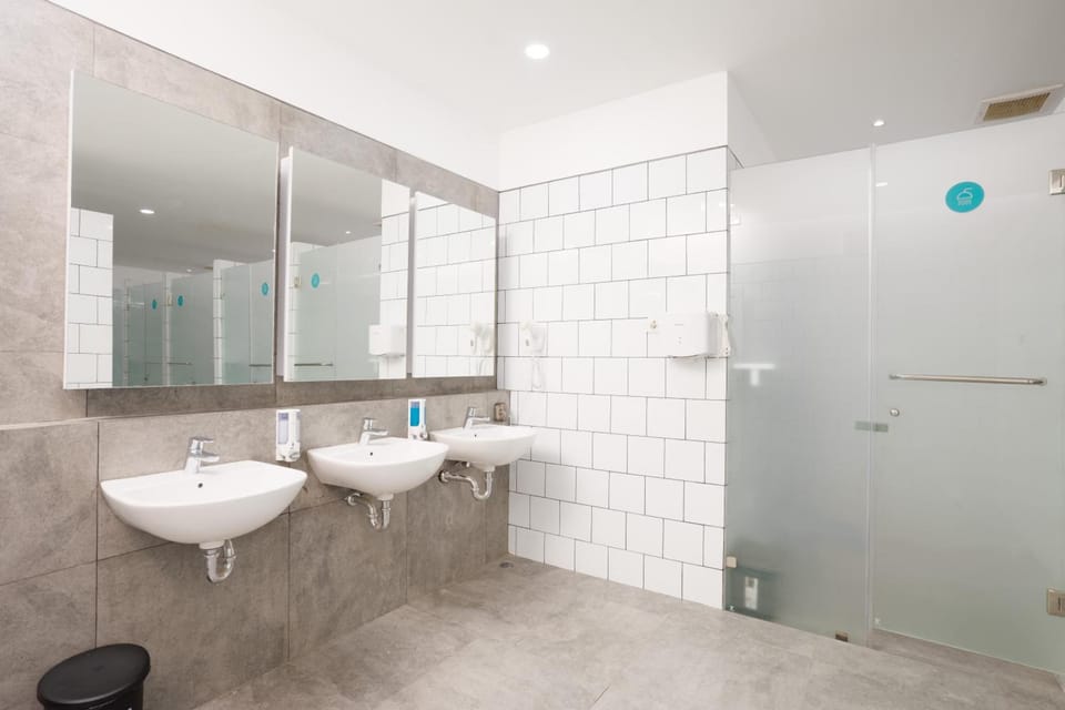 Shower, hair dryer, slippers, towels