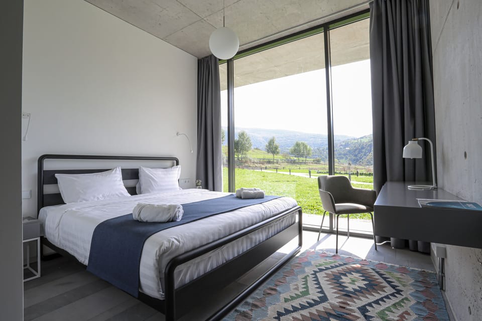 Premium bedding, desk, laptop workspace, blackout drapes