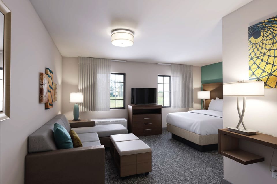Premium bedding, desk, laptop workspace, blackout drapes