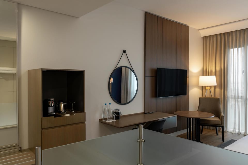 Deluxe Room, Ocean View | Minibar, in-room safe, desk, laptop workspace