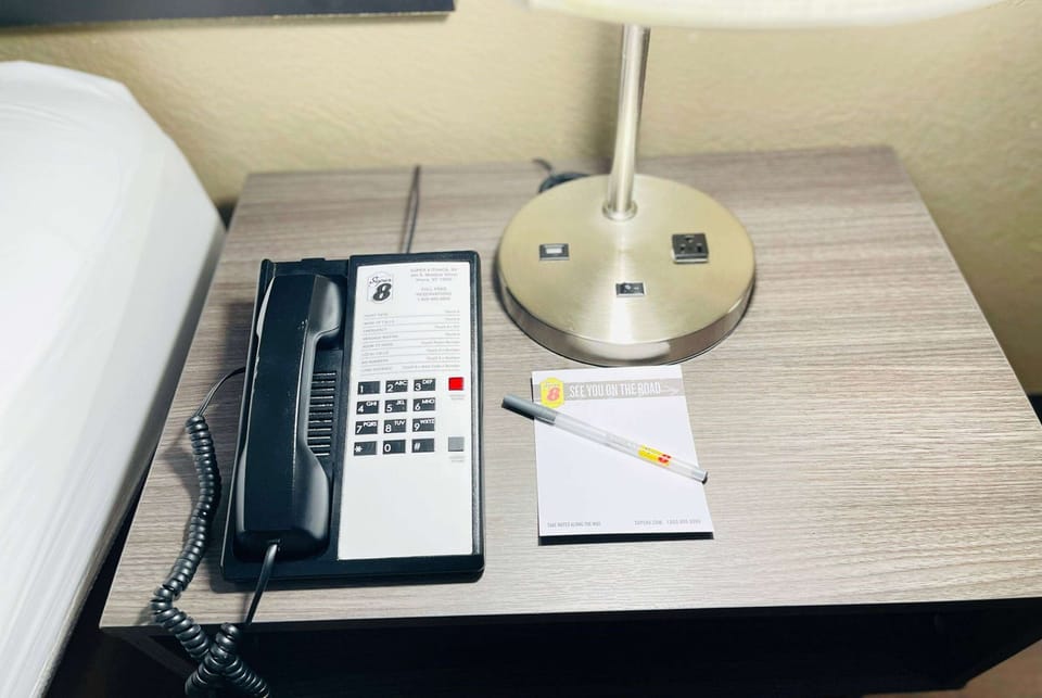 Desk, laptop workspace, blackout drapes, iron/ironing board