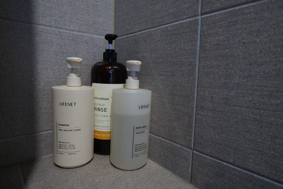Shower, hair dryer, slippers, towels