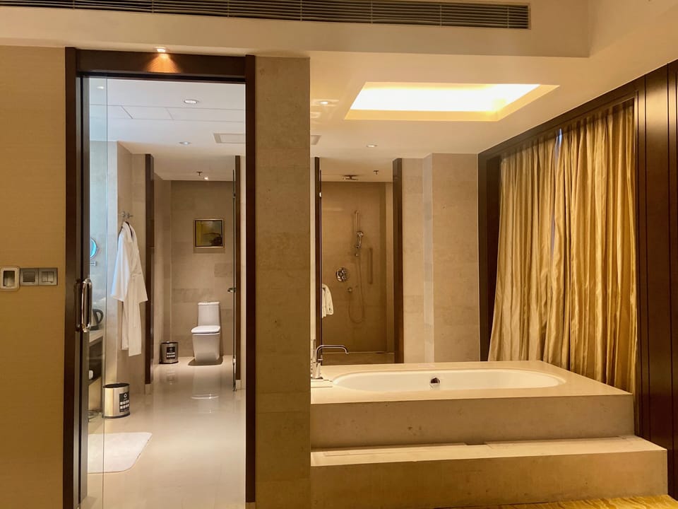 Executive Suite, 1 King Bed, City View | Bathroom | Separate tub and shower, rainfall showerhead, free toiletries