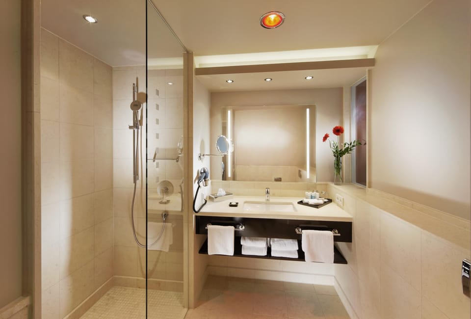 Shower, designer toiletries, hair dryer, slippers