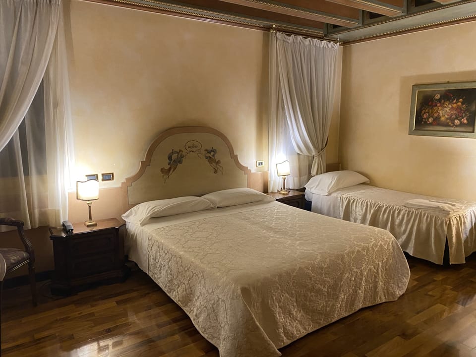 Triple Room | Minibar, in-room safe, individually decorated, desk