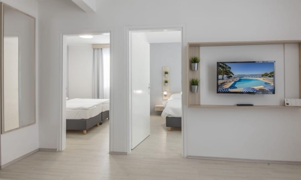 Family Room with seaside balcony | Premium bedding, in-room safe, desk, free WiFi