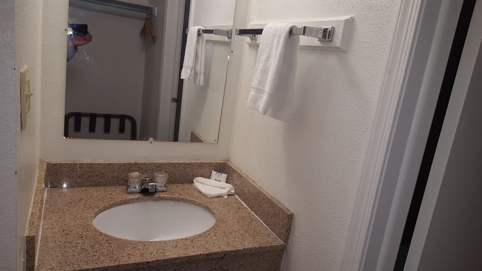 Basic Single Room, 1 King Bed | Bathroom | Combined shower/tub, free toiletries, towels, soap