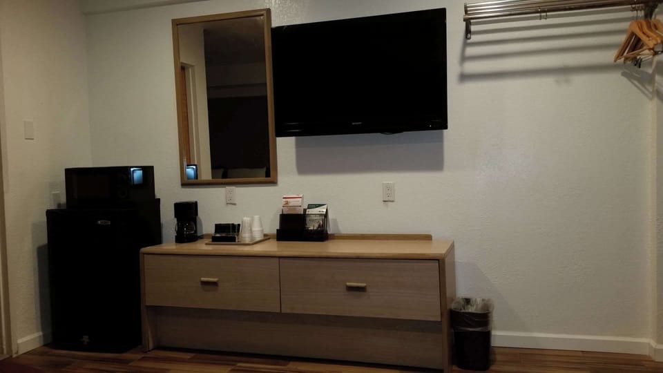 Desk, laptop workspace, blackout drapes, iron/ironing board