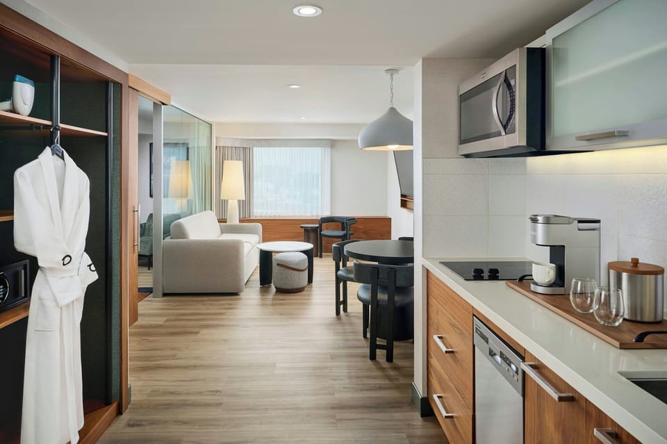 Suite, 1 King Bed | Living area | 55-inch plasma TV with cable channels, TV, pay movies