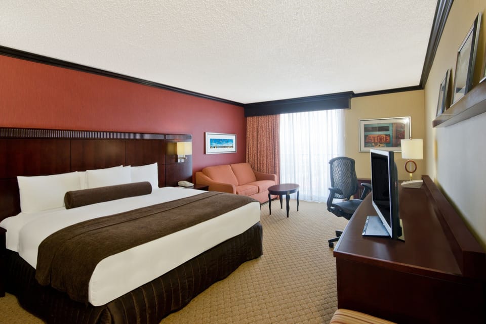 Premium bedding, desk, laptop workspace, blackout drapes