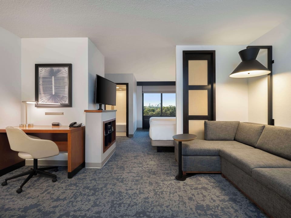 Premium bedding, desk, laptop workspace, blackout drapes