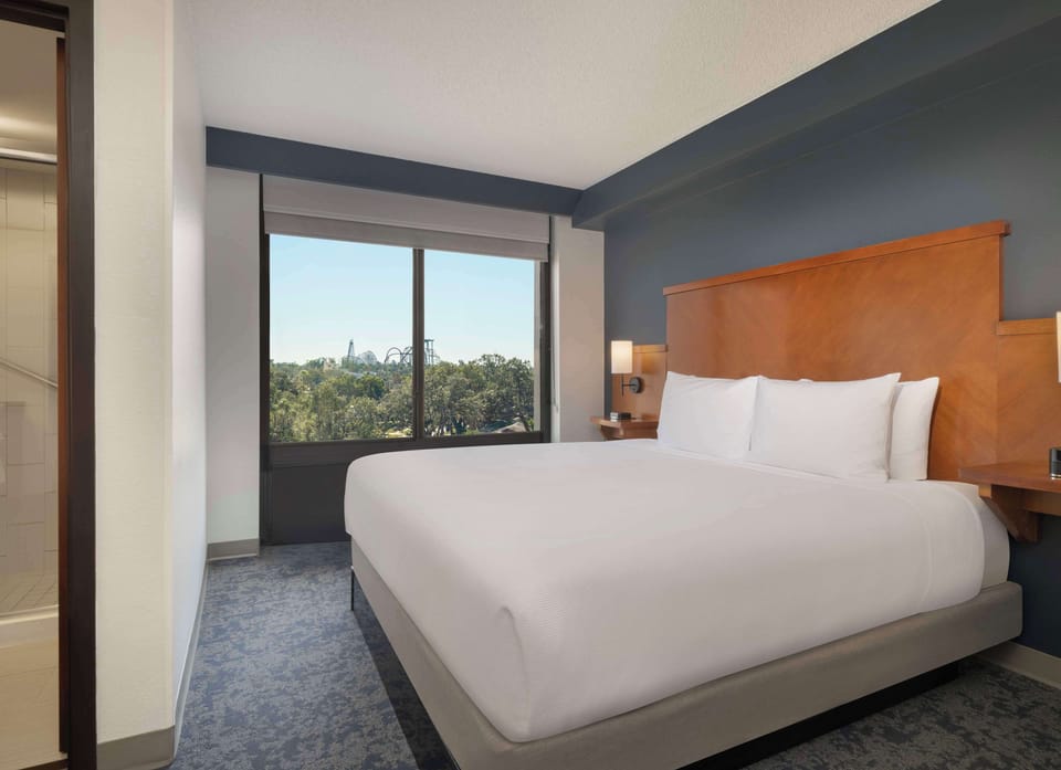 Premium bedding, desk, laptop workspace, blackout drapes