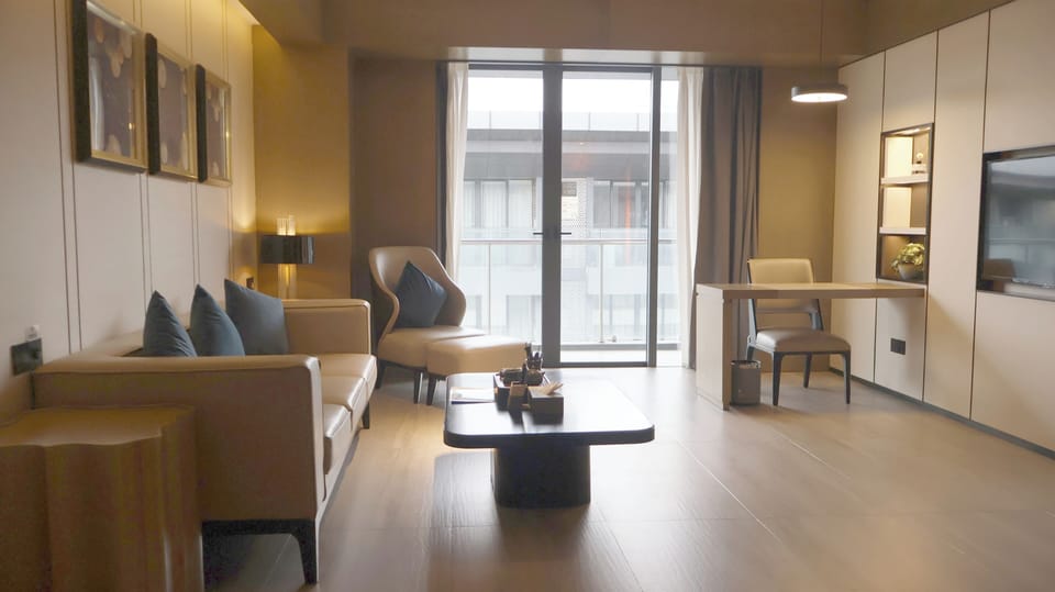 Junior Suite | Living area | 50-inch flat-screen TV with cable channels