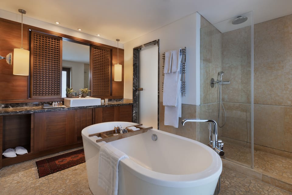 Separate tub and shower, rainfall showerhead, designer toiletries