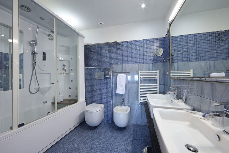 Family Quadruple Room | Bathroom | Deep soaking tub, free toiletries, hair dryer, bidet