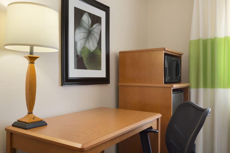 Desk, laptop workspace, blackout drapes, iron/ironing board