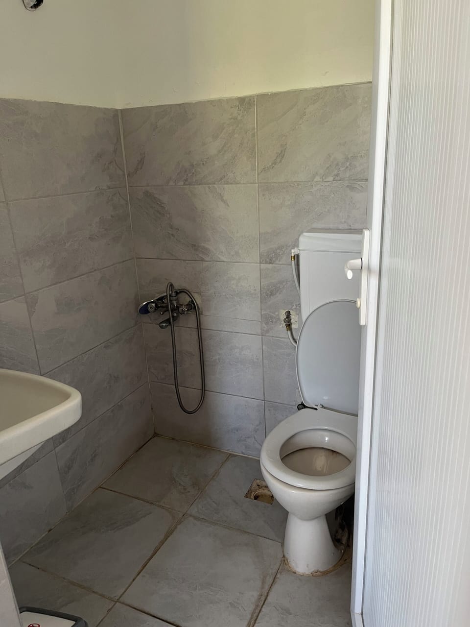 Shower, hair dryer, slippers, towels