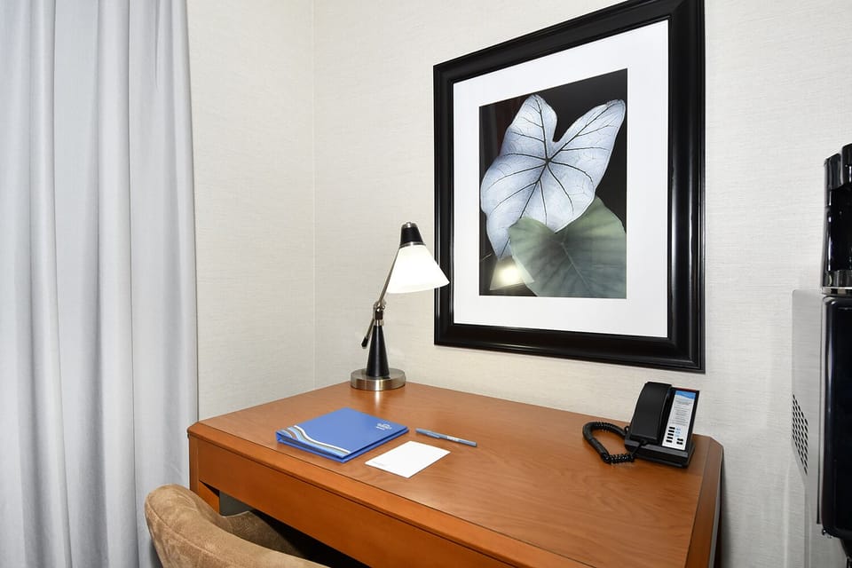 Desk, laptop workspace, blackout drapes, iron/ironing board