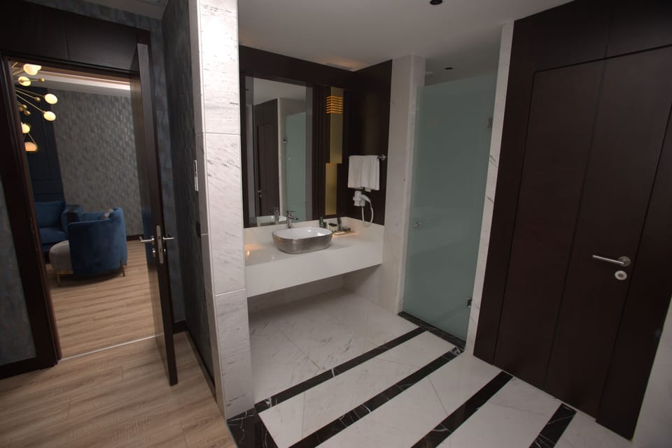 Suite | Bathroom | Designer toiletries, hair dryer, slippers, towels