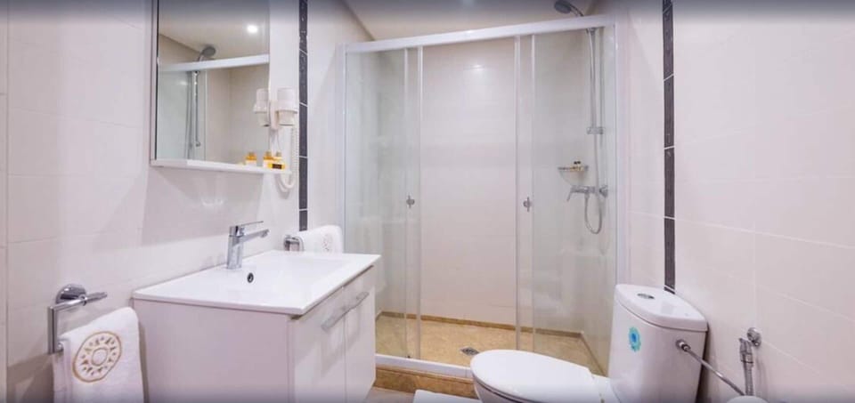 Shower, rainfall showerhead, hair dryer, towels