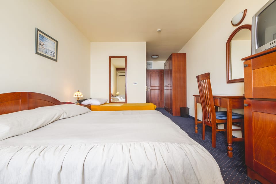 Triple Room, Balcony, Sea View | Minibar, in-room safe, desk, blackout drapes