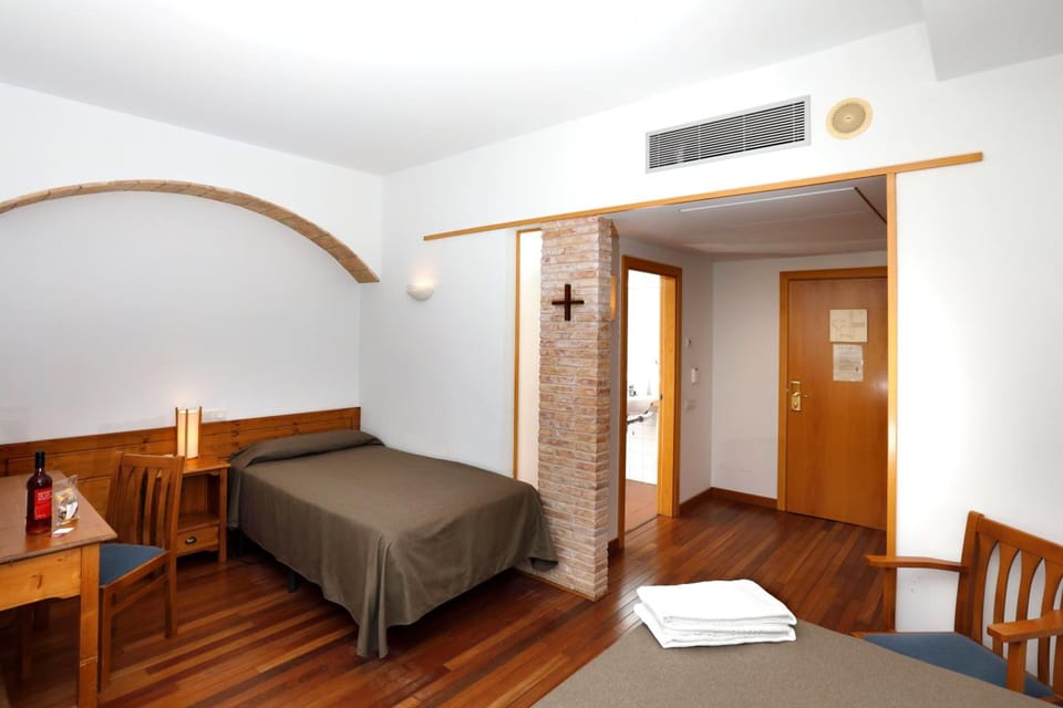 Hypo-allergenic bedding, desk, laptop workspace, blackout drapes