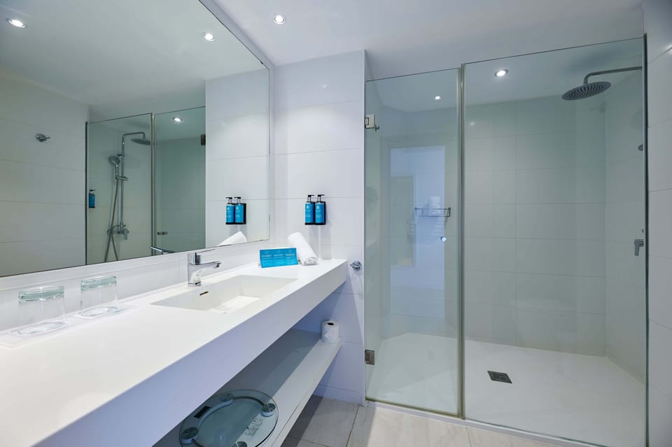 Shower, rainfall showerhead, hair dryer, towels