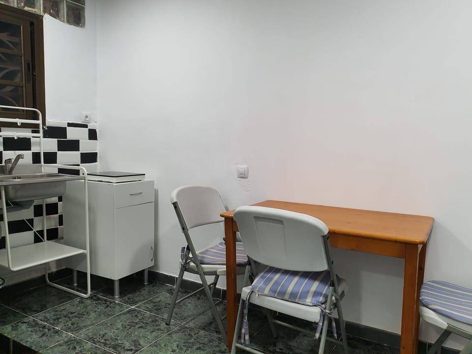 Twin Room, Shared Bathroom | Living area | Flat-screen TV