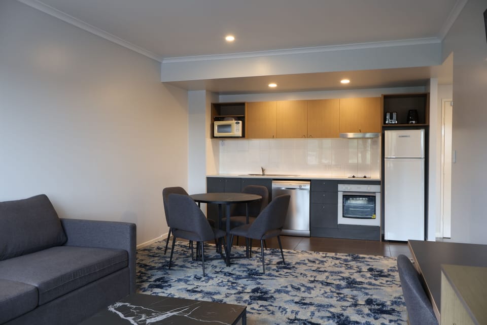 Deluxe 1 Bedroom Apartment | Private kitchen | Coffee/tea maker, full-size fridge
