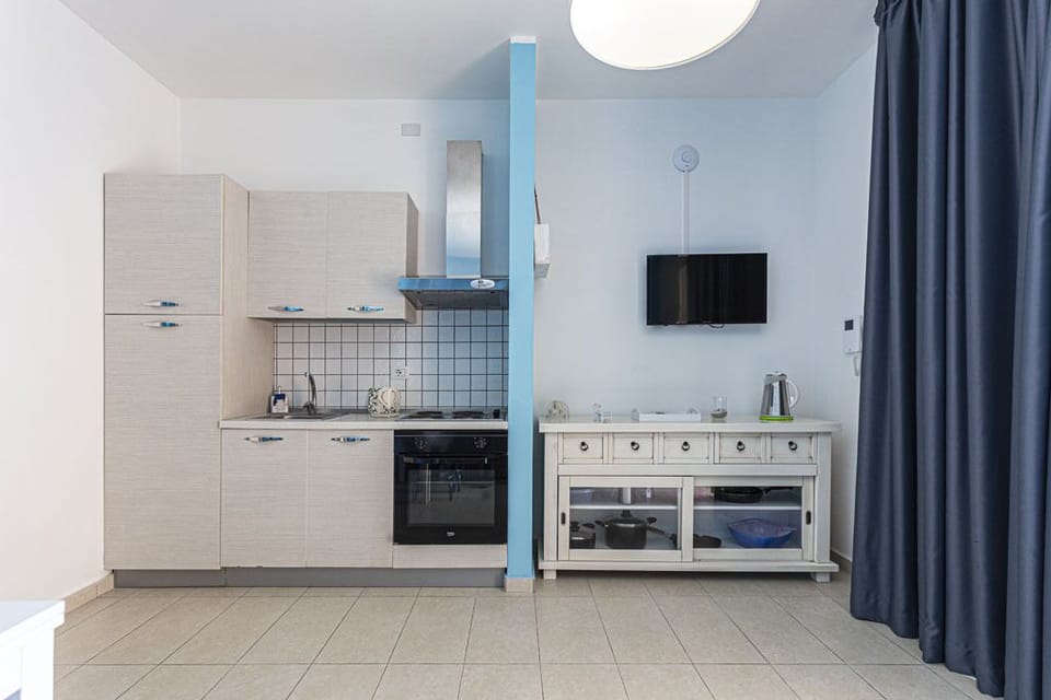 Luxury Apartment | Private kitchen | Espresso maker, electric kettle, highchair, cookware/dishes/utensils