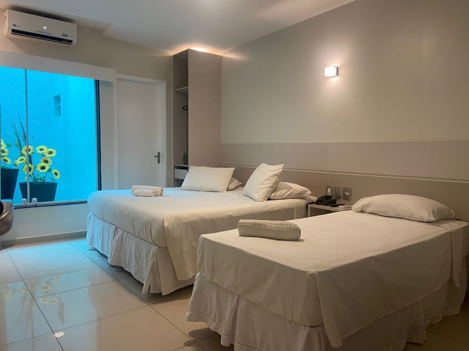 Triple Room | Minibar, in-room safe, blackout drapes, iron/ironing board