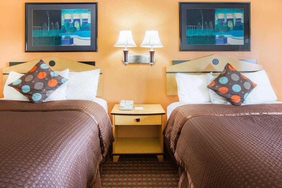 Desk, laptop workspace, blackout drapes, iron/ironing board