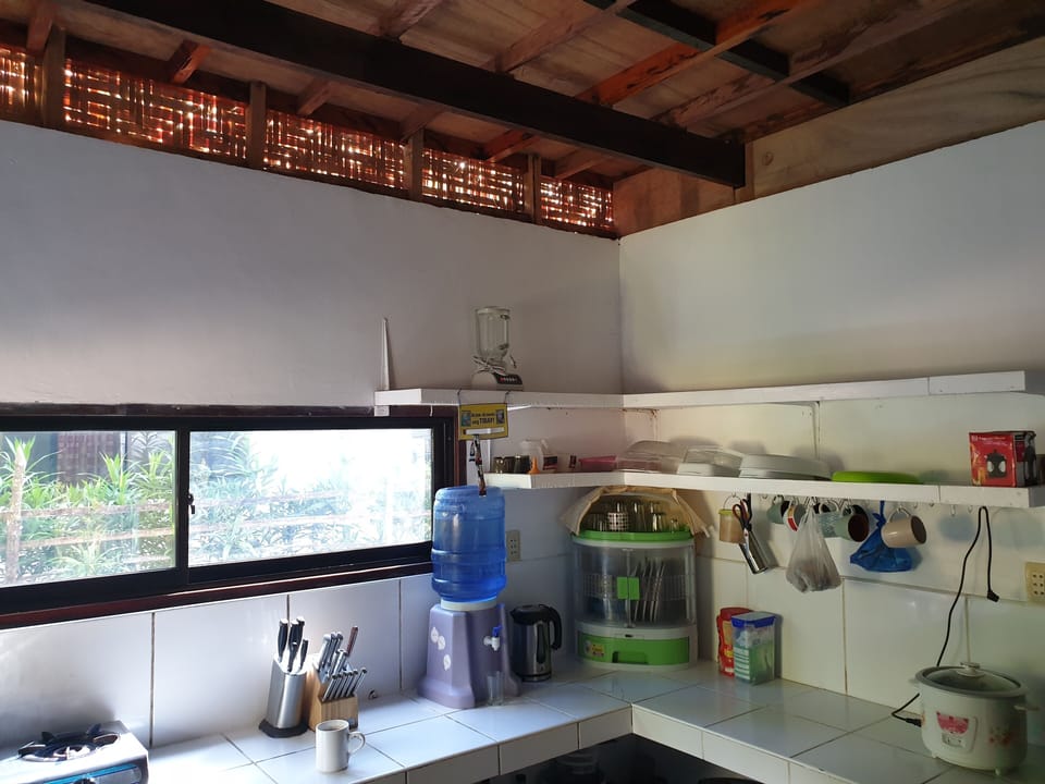 Full-size fridge, stovetop, rice cooker, cookware/dishes/utensils