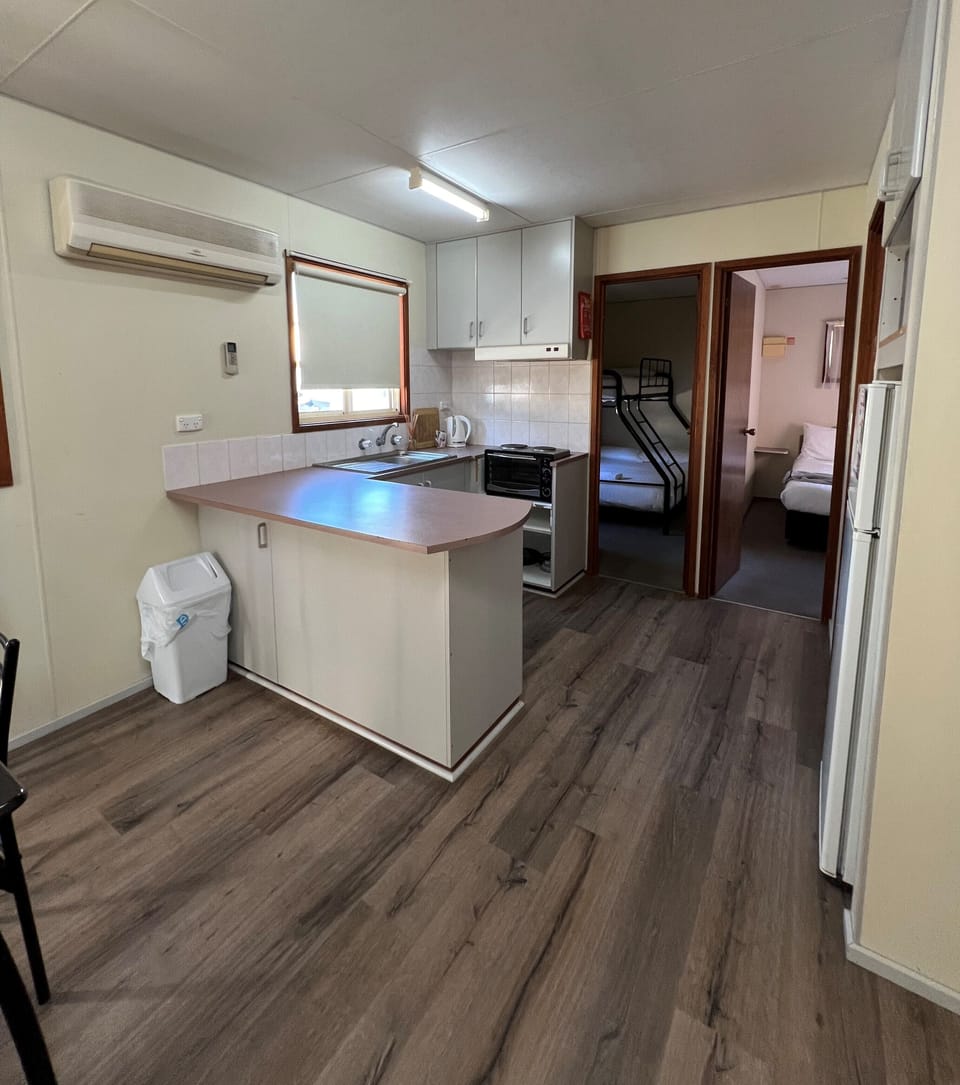 Deluxe Cabin, Pets Not Allowed | Private kitchen | Full-size fridge, microwave, toaster, cookware/dishes/utensils