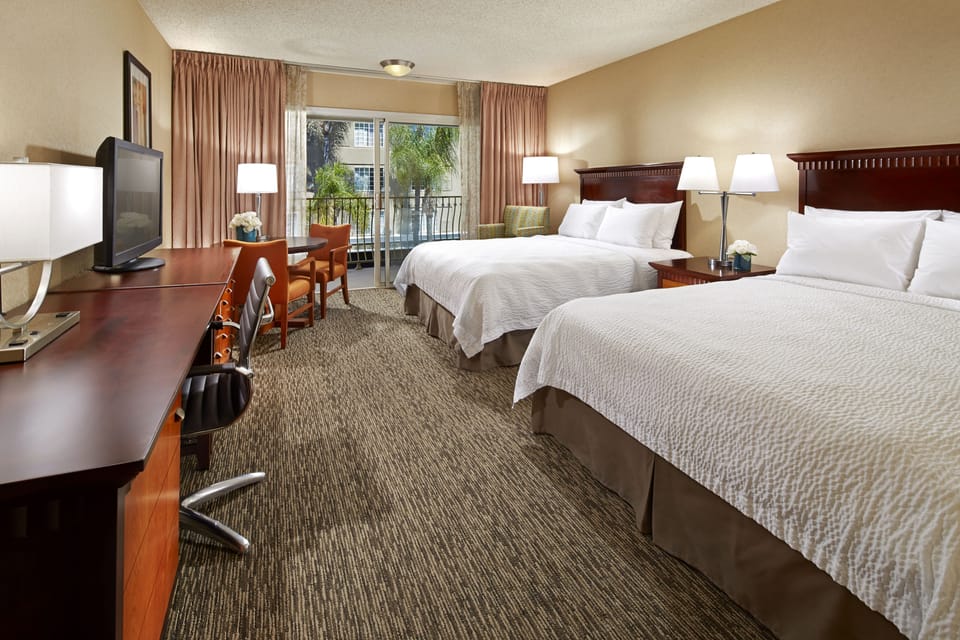 Hypo-allergenic bedding, desk, laptop workspace, blackout drapes