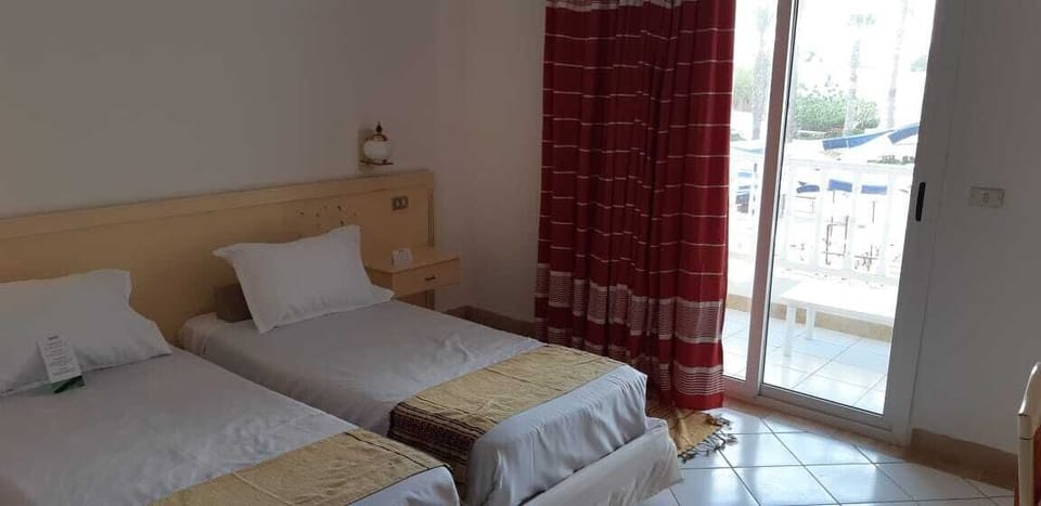 Triple Room | Desk, blackout drapes, iron/ironing board, free cribs/infant beds