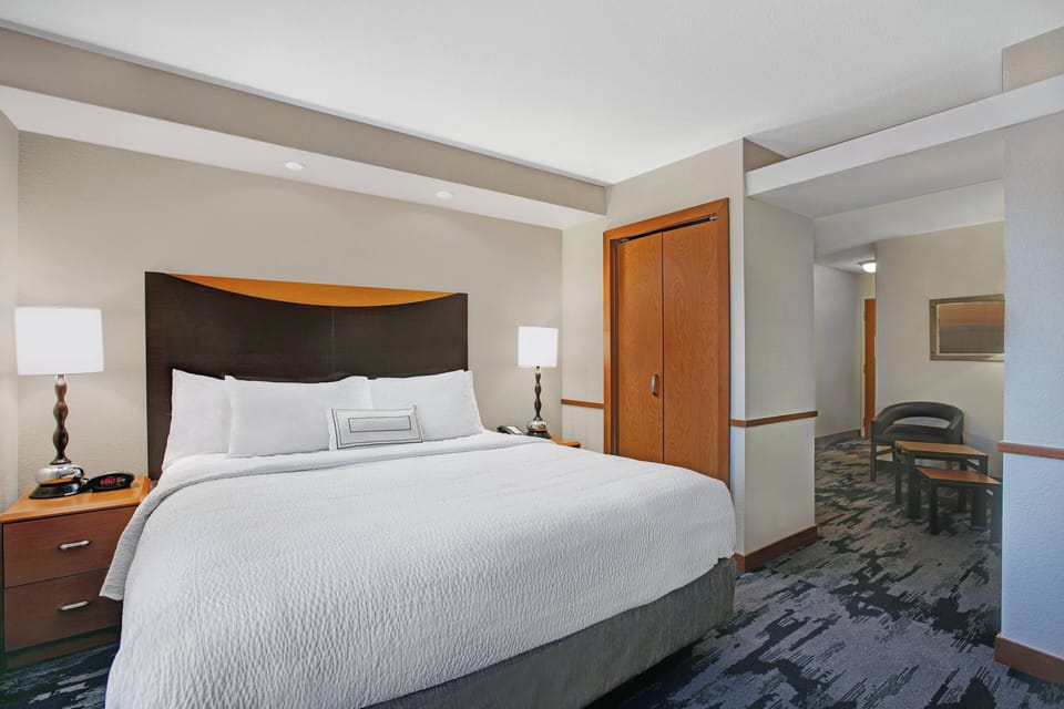 Premium bedding, desk, laptop workspace, blackout drapes